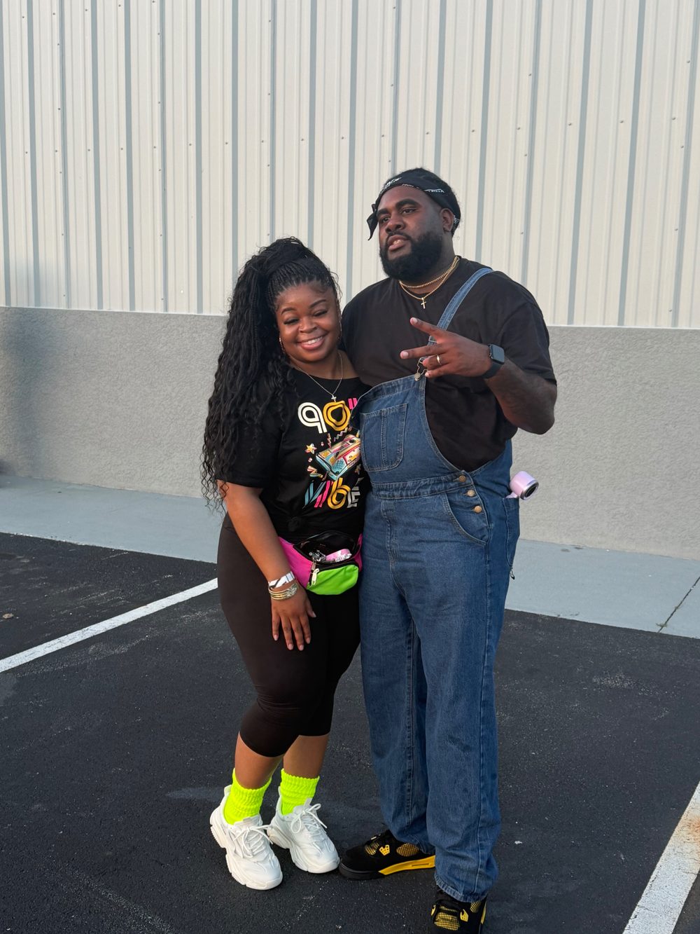 A couple posing in their 90s outfits outside the church after Bible Study Night