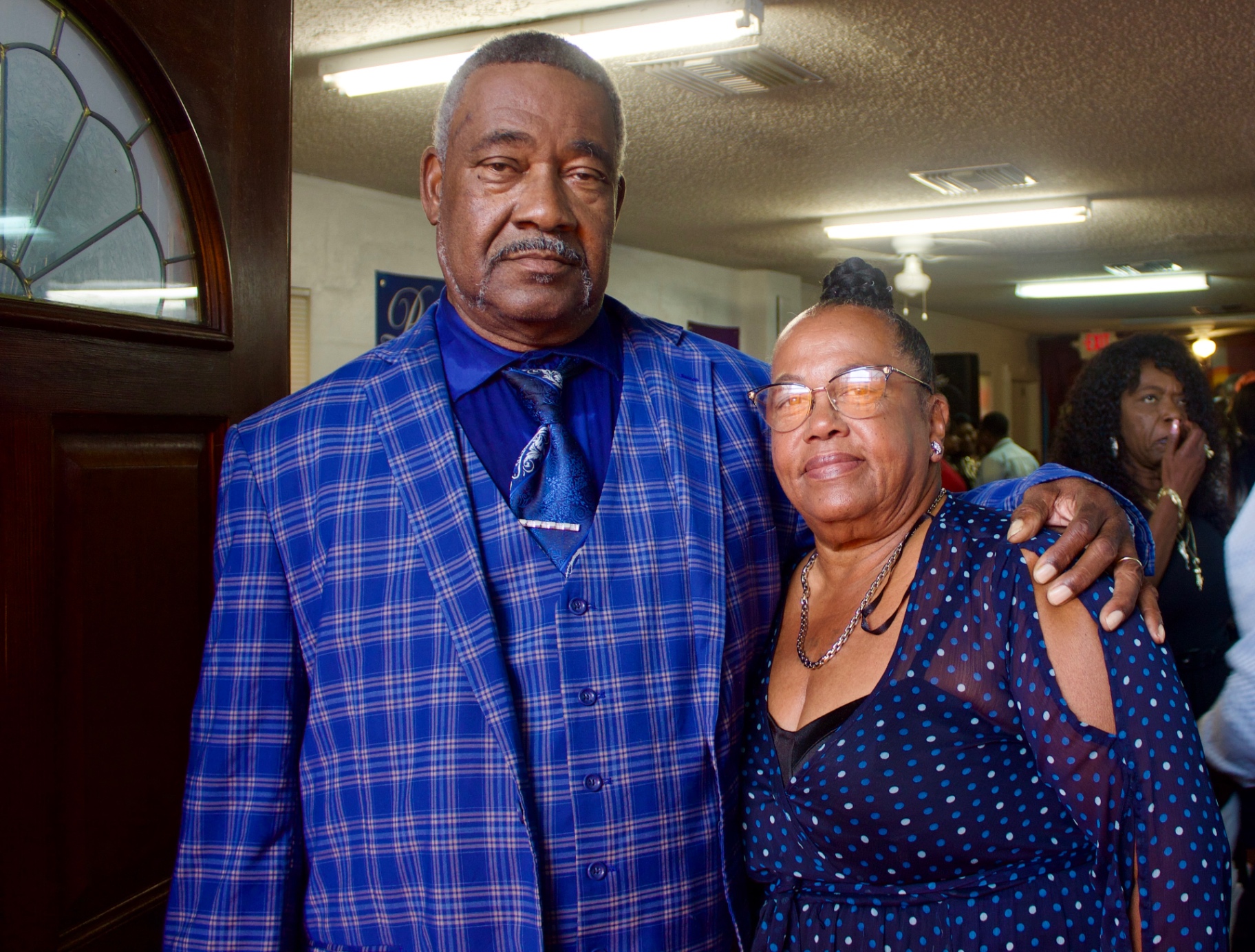 A dignified older couple dressed in their Sunday best for worship